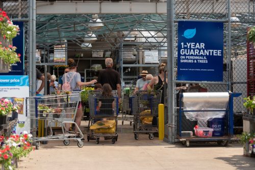 Customers wait to checkout at the garden center of a Lowe's Home Improvement.