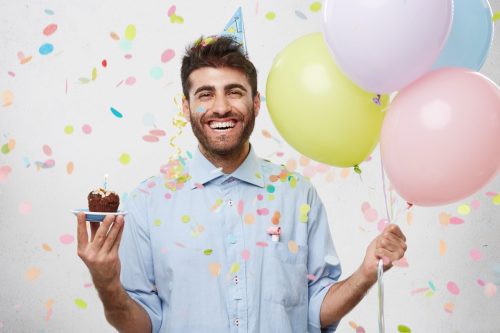 birthday quotes - man holding balloons and cupcake