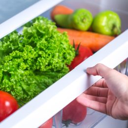 opening fridge with vegetables