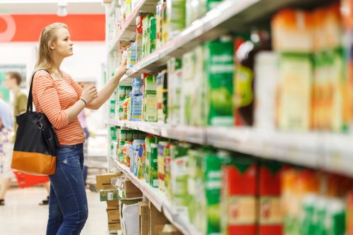 woman looking on grocery store shelf