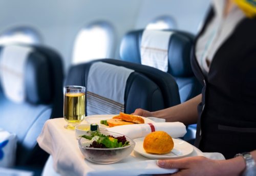 flight attendant serving meal