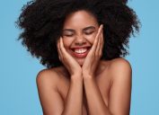 Black Woman Holding Her Face and Smiling