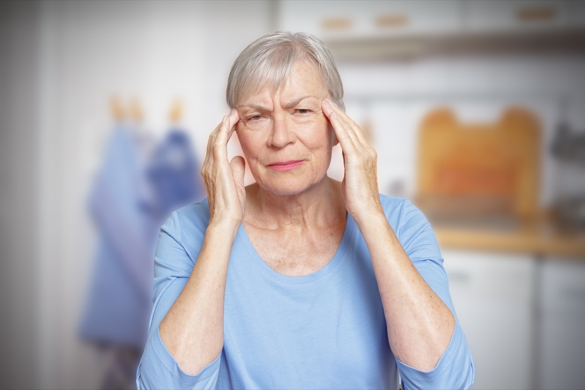 Elderly Woman Holding Her Head in Confusion