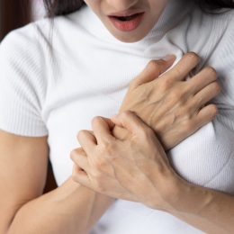 Woman Clutching Her Chest in Pain