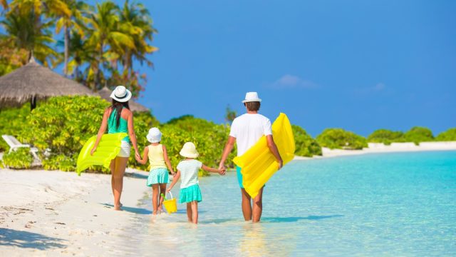 Family of Four Walking on the Beach