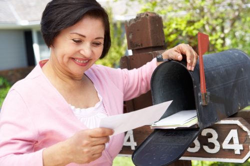woman receiving check in the mail