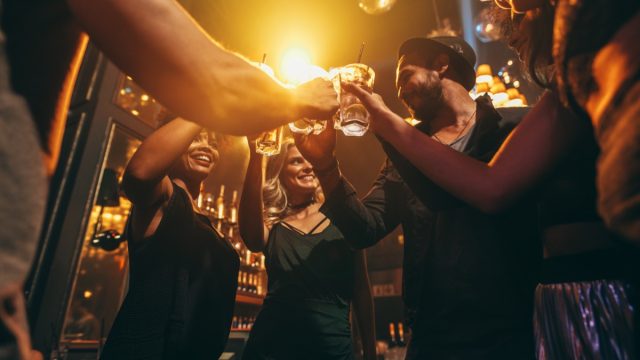 people toasting at a bar