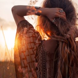 back of a woman's head and sunset