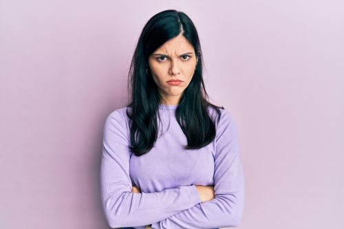 woman in purple shirt looking angry