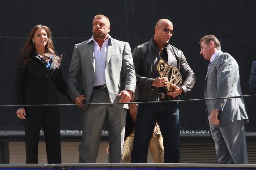Stephanie McMahon, Triple H, The Rock, and Vince McMahon at a WrestleMania press conference in 2013