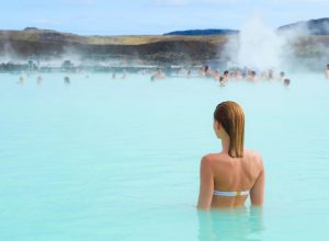 woman enjoying blue lagoon hot springs in Iceland