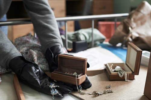 Burglar Stealing Items From Bedroom During House Break In