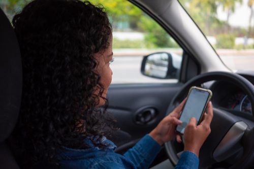 Woman using cellphone while driving