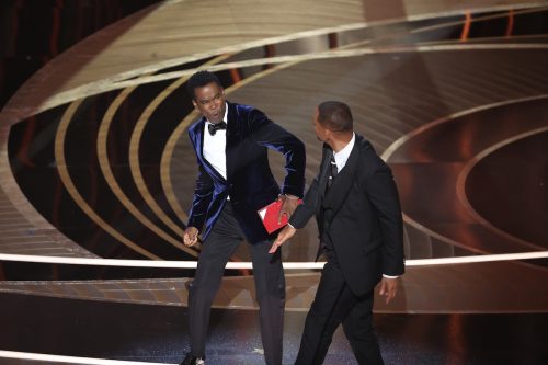 Will Smith slapping Chris Rock on stage at the 2022 Oscars