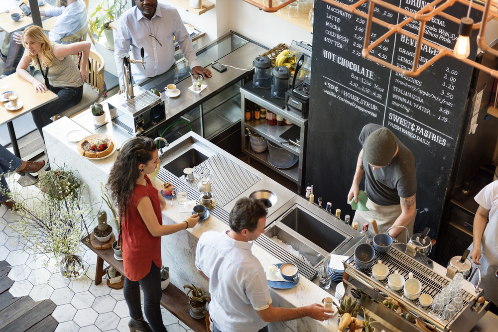 The interior of a busy coffee shop at the counter