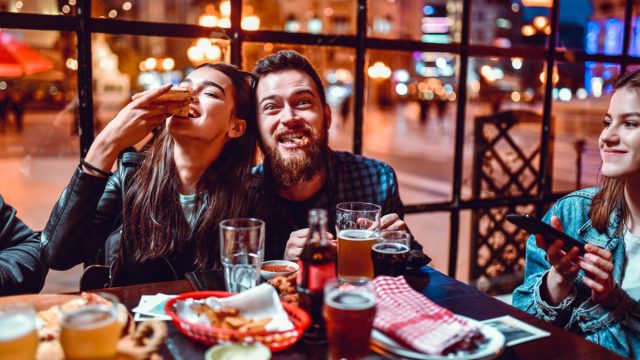 young couple eating pizza
