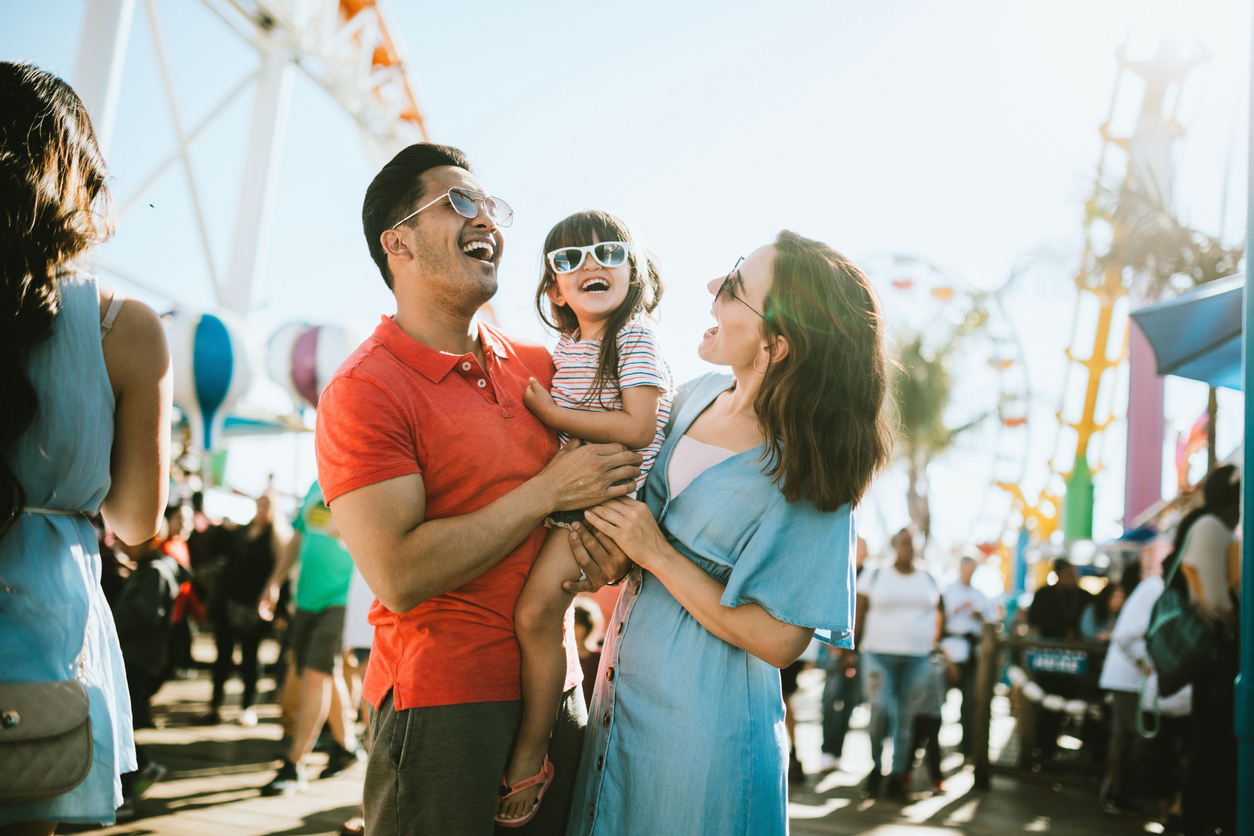 A family with their young child at an amusement park
