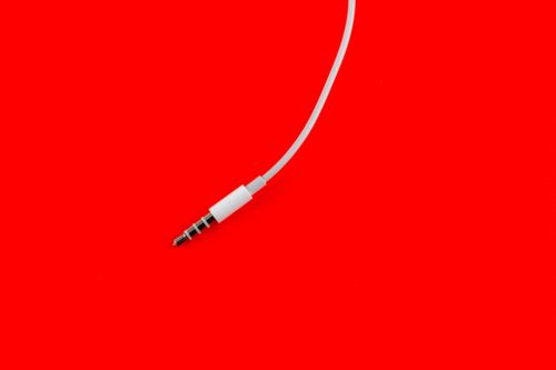 Headphone plug on a red background