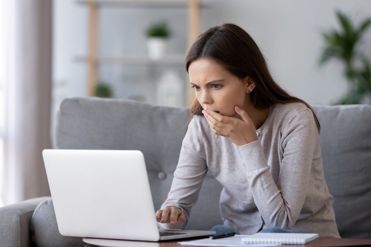 woman looking concerned at computer