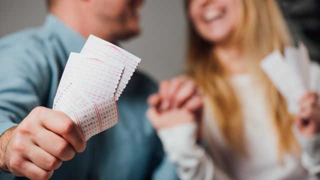 Couple holding lottery tickets