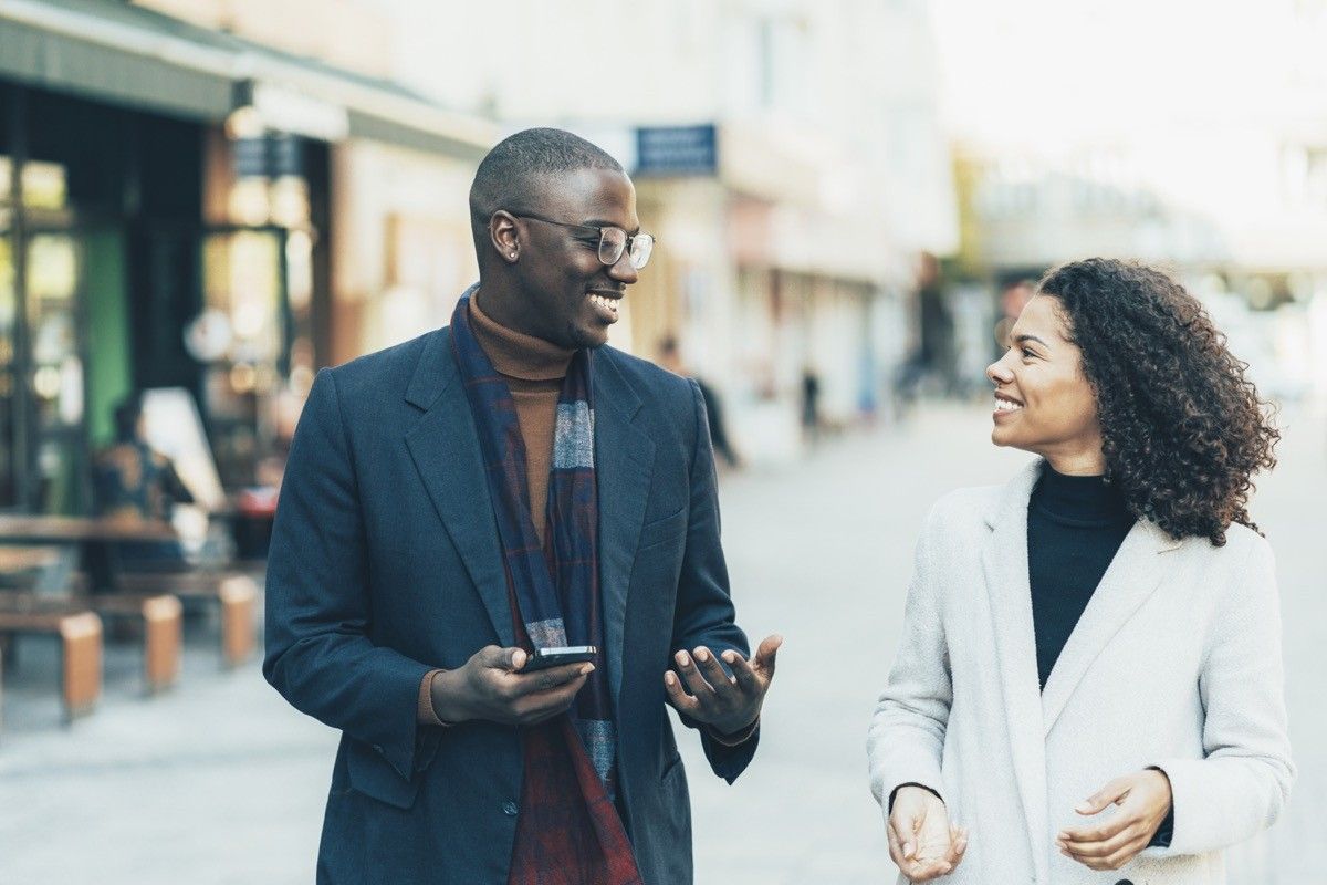 Shot of an affectionate young couple bonding together outdoors. Portrait of an adorable african-american young couple walking outdoor in the city.