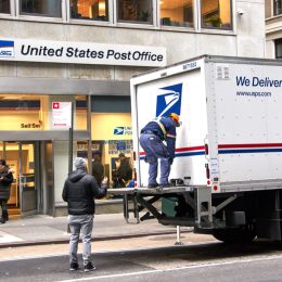 USPS postman on a mail delivery truck in New York. USPS is an independent agenc of US federal government responsible for providing postal service in the US.