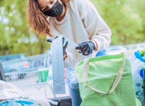 photo of young woman, she packing their groceries in her car