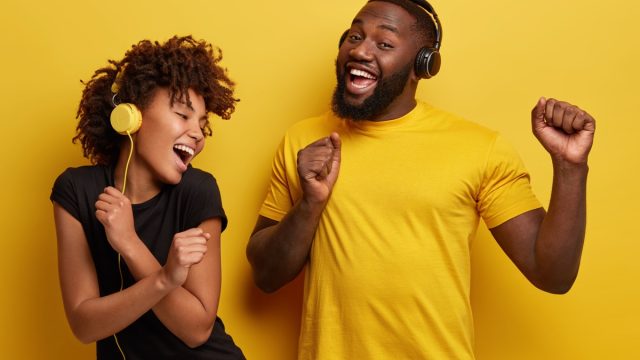 Two Black People Dancing and Listening to Music