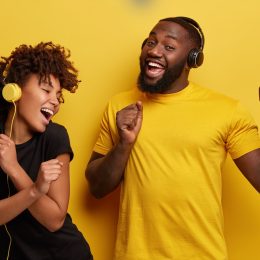 Two Black People Dancing and Listening to Music