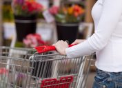 woman pushing shopping cart into grocery store