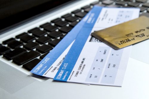 boarding passes and credit card on laptop