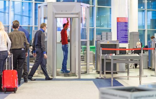 man going through security checkpoint