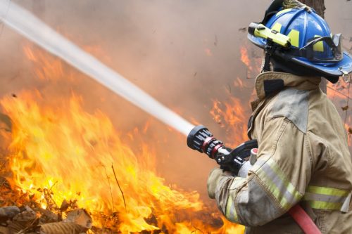 firefighter battling wildfire