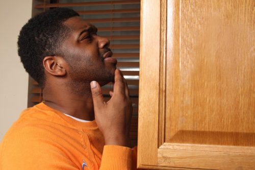 man looking in pantry