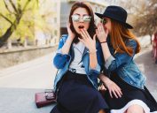 two women gossiping with sunglasses on