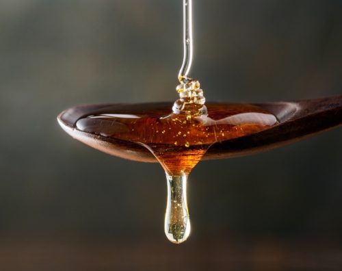 honey dripping on the spoon