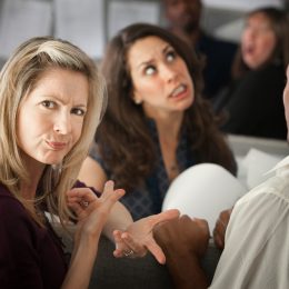 woman frowning and pointing to another woman