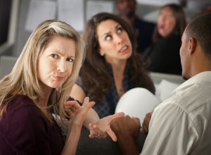 woman frowning and pointing to another woman