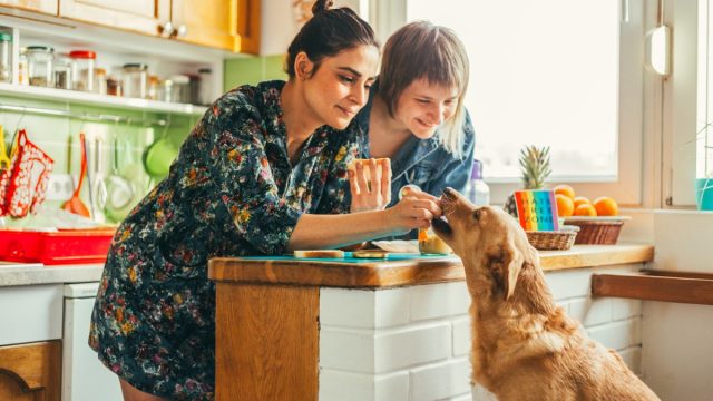 two women at home with their dog