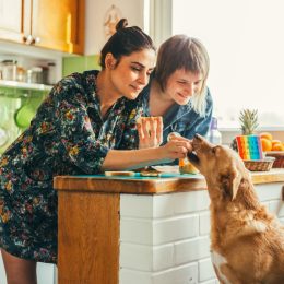 two women at home with their dog