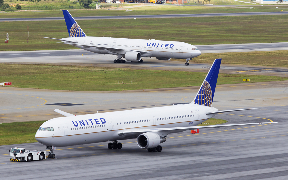 Two United Airlines planes taxiing on a runway