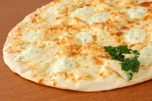 Gourmet white pizza with fresh mozzarella and herbed ricotta cheese