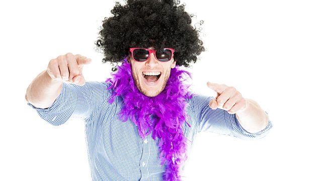 Wild man in party wig and boa