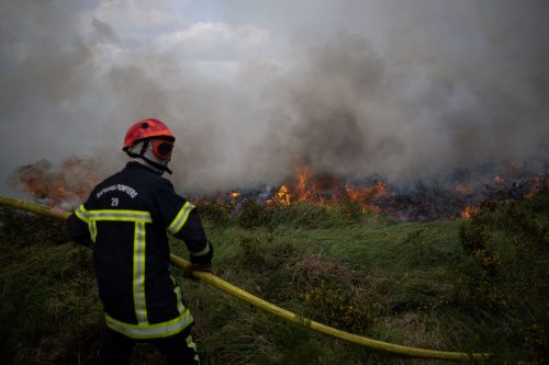 A firefighter near a wildfire in Monts d'Arree near Basparts, Brittany, France in July 2022
