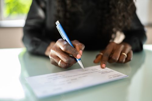 Woman Writing Check. Payroll Salary Cheque