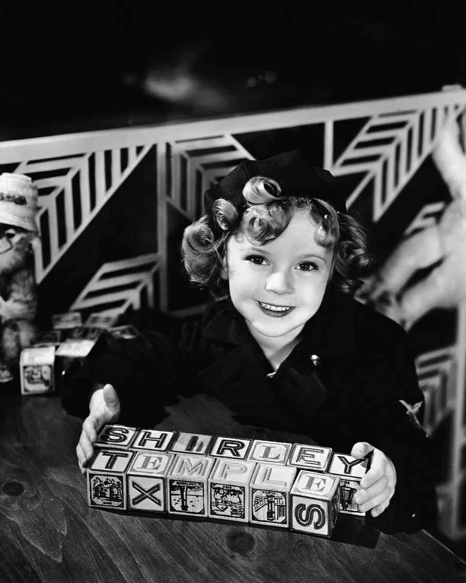 Shirley Temple with blocks spelling out her name
