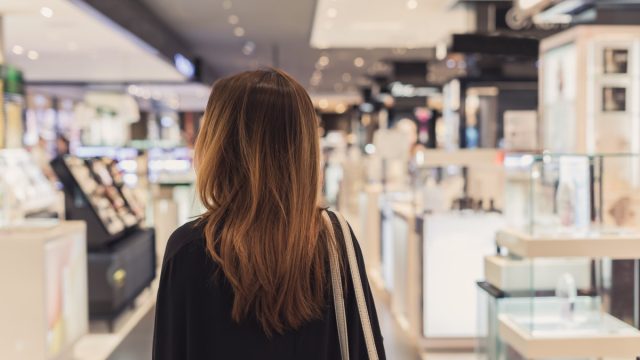 woman walking in cosmetics department at the mall