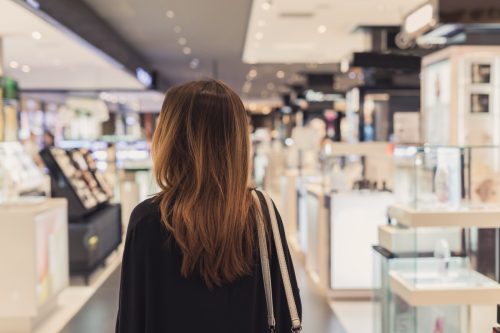 woman walking in cosmetics department at the mall