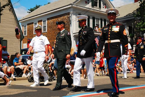 Members of all four United States armed services, in their formal dress, march in a Fourth of July parade in Bristol, Rhode Island