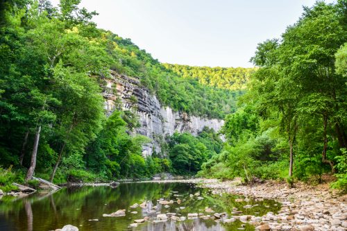 The Buffalo National River in Arkansas with large cliffs alongside
